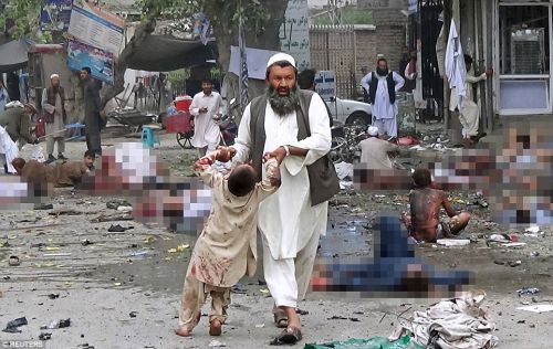 27B1070A00000578-3044582-A_man_leads_an_injured_boy_by_the_hands_after_the_suicide_attack-a-21_1429438552936