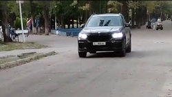 BMW X5 едет по аллее в парке имени Ататюрка. Видео