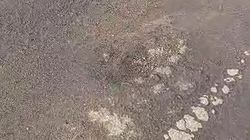 Новый асфальт на Ауэзова начал рассыпаться. Видео горожанина