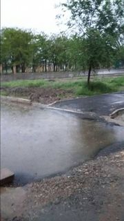 По улице Садыгалиева в Бишкеке из-за неправильно проложенного асфальта после дождя образуются лужи